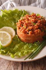 Turkish appetizer spicy Kisir close-up on the table. vertical
