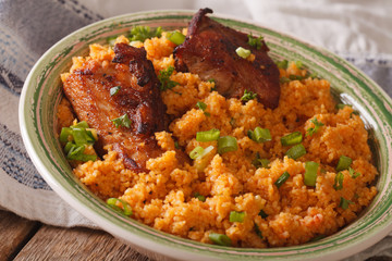 Pilaf bulgur with beef close-up on a plate. horizontal
