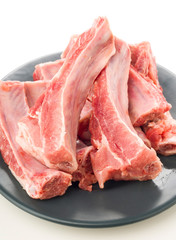 plate of raw pork ribs on white