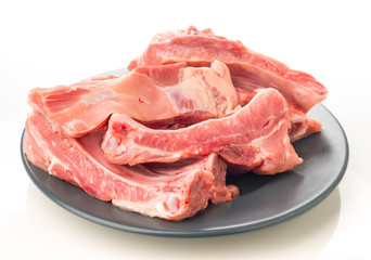 plate of raw pork ribs on white