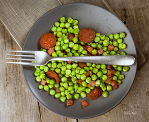 cenital take dish cooked with ham and chorizo peas in old wooden