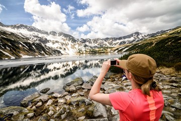 Young woman taking photo of 5 Ponds Valley