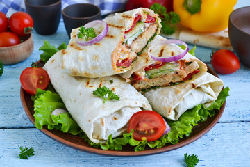 shawarma Lavash with chicken, tomatoes, lettuce and peppers on a