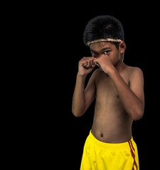 Naklejka premium a child boxer isolated on black backguornd/black lighting