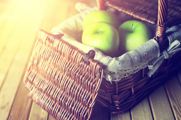 sunlight green apple in a basket wooden background