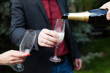 Pouring champagne into a glass on a wedding celebration