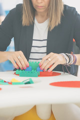 Fototapeta premium Close-up of adult woman playing with blocks