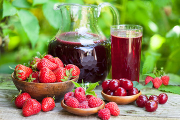 Strawberry, sour cherry and raspberry juice in pitcher and glass