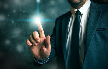 Businessman pushing virtual screen interface button