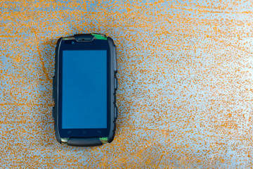 Phone on rusty metal sheet