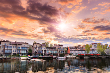 Fototapeta premium Majestic sunset. dramatic colorful clouds over the lake, reflec