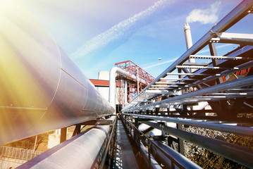 Industrial zone, Steel pipelines and valves against blue sky