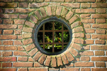 Old round window on brick wall