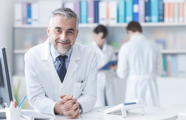 Confident doctor at the reception desk