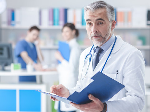 Confident doctor checking medical records