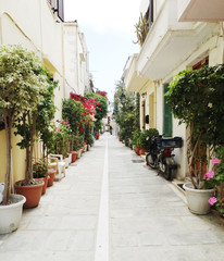 Fototapeta na wymiar traditional street amoung bougainvillaea in rethymno city Greece
