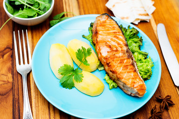 Grilled salmon on wooden background