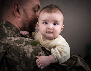 Kids Against War. The child in the arms of a soldier.