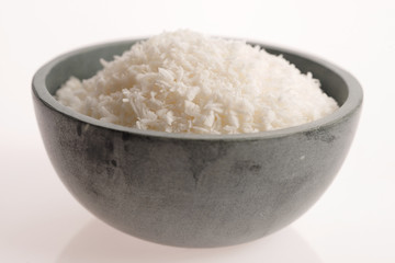 Coconut flakes in ceramic bowl