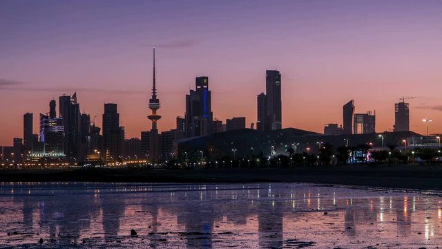 Seaside skyline of Kuwait city from night to day timelapse