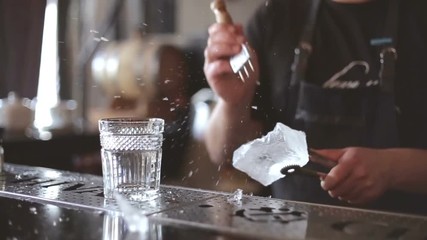 Bartender mannually crushed ice with wooden metal knife. - Powered by Adobe