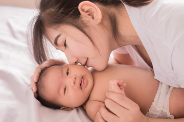 Happy mother holding adorable child baby boy
