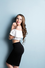 Fototapeta premium Fashionable young brunette woman posing in studio.