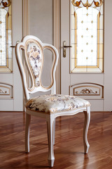 Beautiful and fashionable, Vintage Wooden chair in the room. object furniture in classic style. white tree with gold trim. patina. carving. luxury furniture. use in design