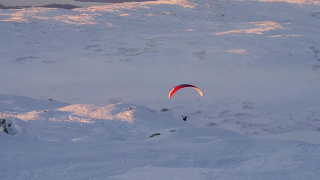 Paraglider fly in mountains