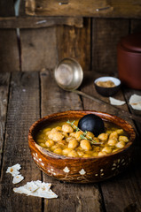 Chickpea spicy soup on wooden vintage background. Arabian food. Selective focus