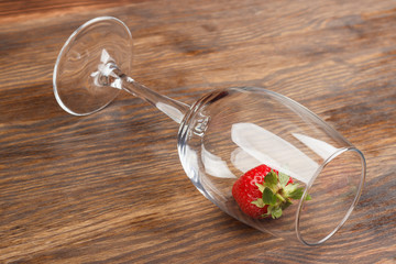 Wineglass with red ripe strawberry inside