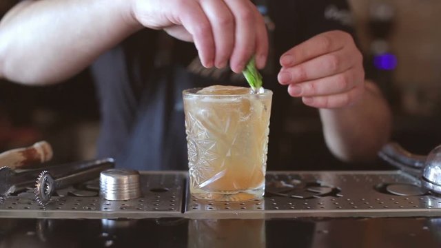 Barthender makes cocktails at the bar