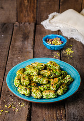 Maamoul - arabic cookies with pistachio in metal bowl on vintage wooden table background. Selective focus