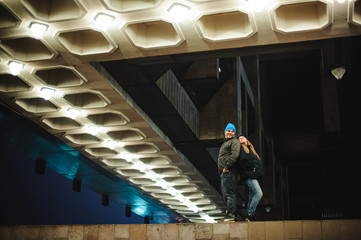 Couple walking through town together at night