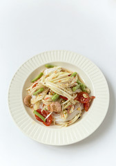Spicy Thai style papaya salad on white background