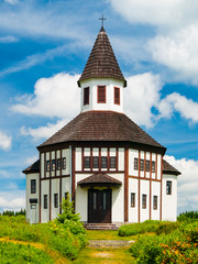 Fototapeta na wymiar Small wooden evangelical chapel in Korenov