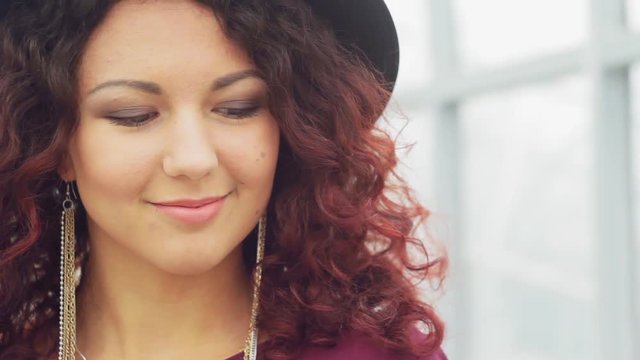 Beautiful curly-haired woman in a long dres