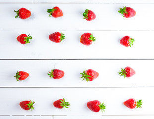 Beautiful background with fresh ripe strawberries on white wooden background