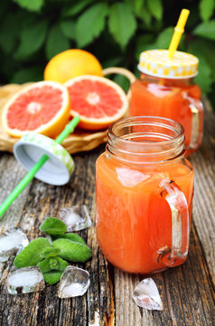 Grapefruit juice in two glass jar, open-air drink