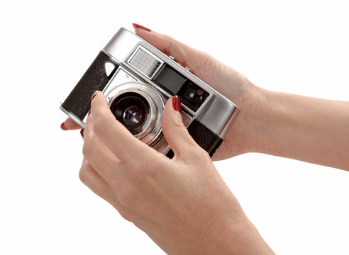 Woman hands and old camera