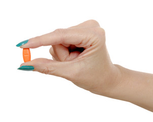 Fototapeta premium woman hand and orange pill