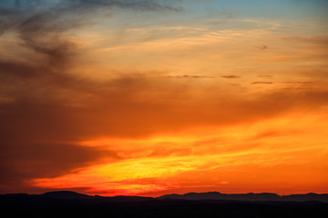 Fototapeta na wymiar Vibrant sunset above landscape