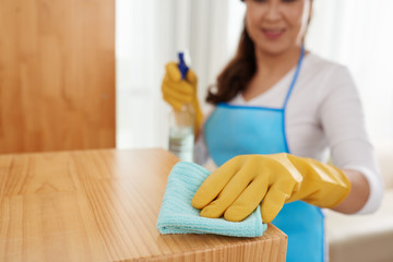 Cropped image of woman cleaning surface with detergent