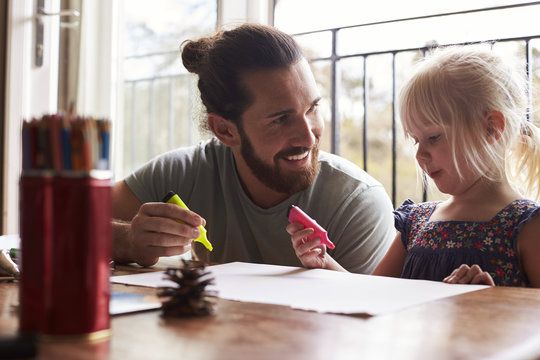 Father And Daughter Drawing At Home 