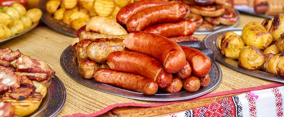 grilled sausages on a plate on a table close-up