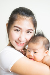 Happy mother holding adorable child baby boy