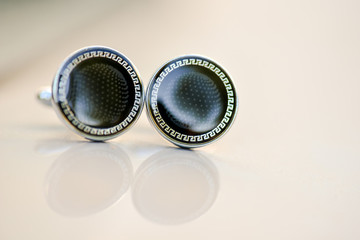 Cufflinks with black stone and reflection in natural light