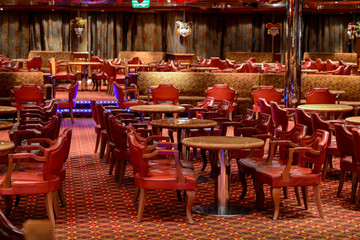 Restaurant with stone tables and red leather chairs