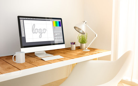 minimalist workplace with graphic design computer