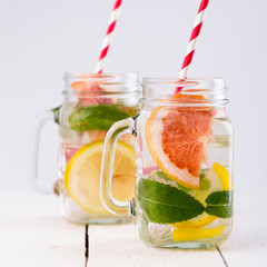 Homemade healthy smoothie with fresh fruits and ice in jar.